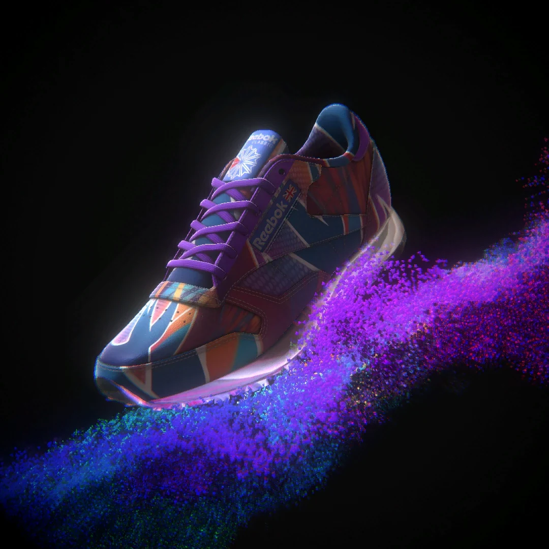 Reebok Classic sneaker with purple laces and a multicolour patchwork design above violet particles